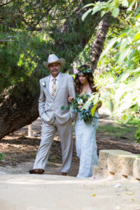 cowboy hat father with flower crown bride