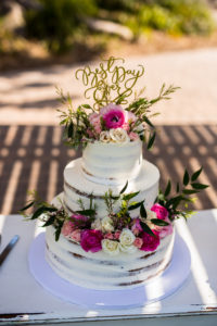naked cake with pink and white flowers