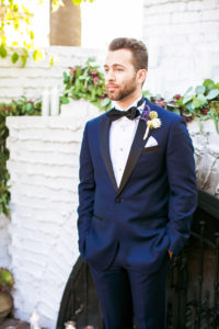 navy suit with lavender boutonniere
