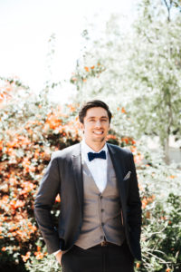 dapper groom with navy bow tie