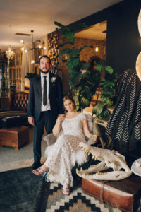 bride and groom at eclectic warehouse wedding venue los angeles with antiques