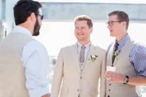 groom and groomsmen in light suits and grey ties