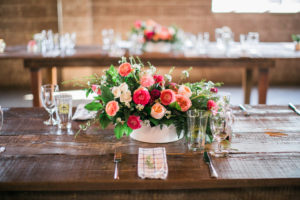 pink, coral and peach flowers on farm tables