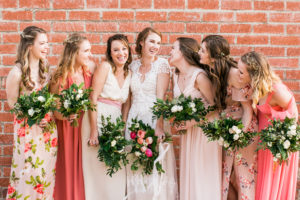 bride and bridesmaids in front of brick wall smoky hollow studios