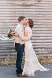 bride and groom kiss outside smoky hollow studios