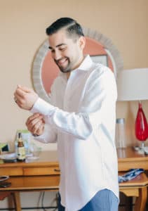 groom getting ready white shirt