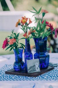 bright blue bottles and flowers with marble table number