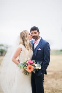 bride and groom with colorful bouquet