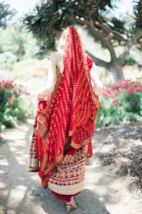 back of lehenga red and gold on blond american bride