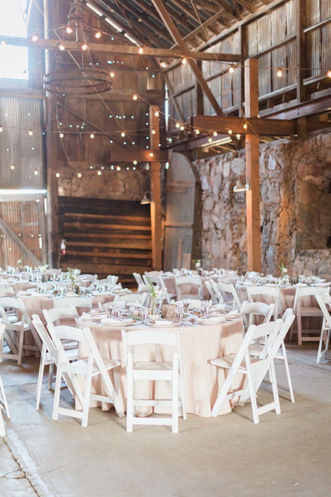 Barn wedding with bistro lights and stone walls