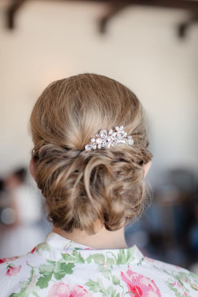 Bride updo with jeweled hair piece and loose curls