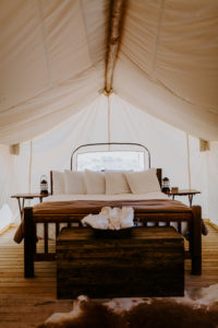 The bed inside under canvas moab glamping tent