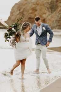 Wave gets bride and groom wet during elopement in Laguna Beach