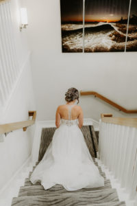 Bride walking down the stairs before the First Look at Pacific Edge Hotel in Laguna Beach