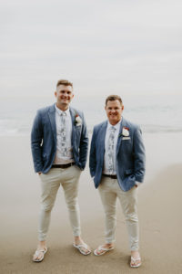 Groom and best man in light blue jackets and kaki pants before the ceremony in laguna beach
