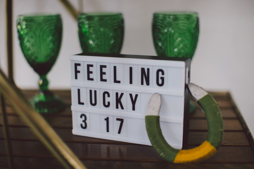 Feeling Lucky on light up sign for St Patrick's Day dinner party. Green goblets and a yarn wrapped horse shoe