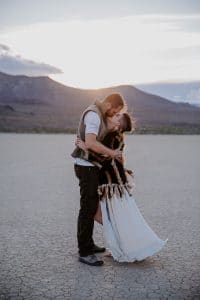 A bride and groom in the desert for their festival style wedding.