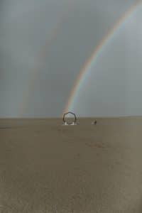 A double rainbow formed over a desert wedding ceremony.