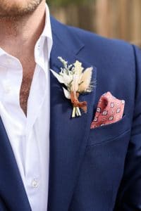 Dark blue groom suit with coral pocket square