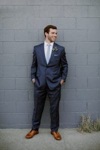 Groom suit in navy with blue tie and brown shoes