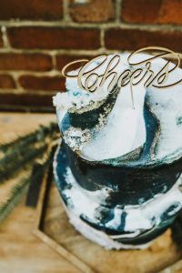 Cheers cake topper on geode cake